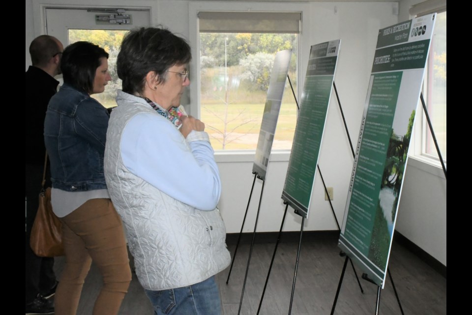 A resident reviews some of the proposed priorities in the master plan. Photo by Jason G. Antonio