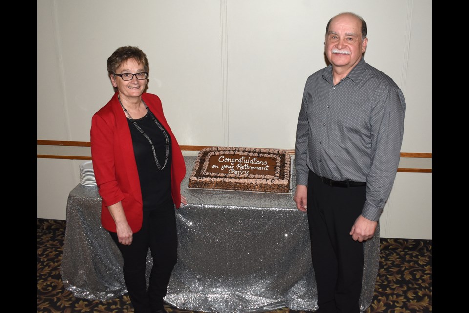 Lorna and Gerry Onyskevitch with the cake wishing him good luck during Gerry's retirement after 42 years with the Co-op, 27 in Moose Jaw.