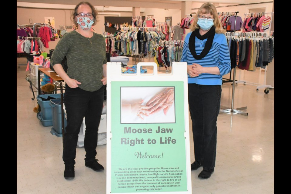 Amy Pryadko and Jean Landry, president of Moose Jaw Right to Life, gather in the new Right to Life Centre in the basement of First Baptist Church at 1010 Main Street. The new location gives more space for more racks to display baby and children's clothing. Photo by Jason G. Antonio 