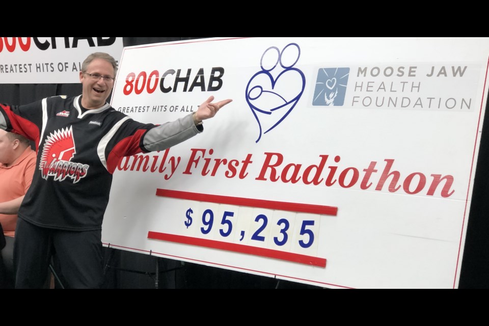 Kelly McElree, executive director of the health foundation, shows his excitement after updating the money board. Photo by Jason G. Antonio