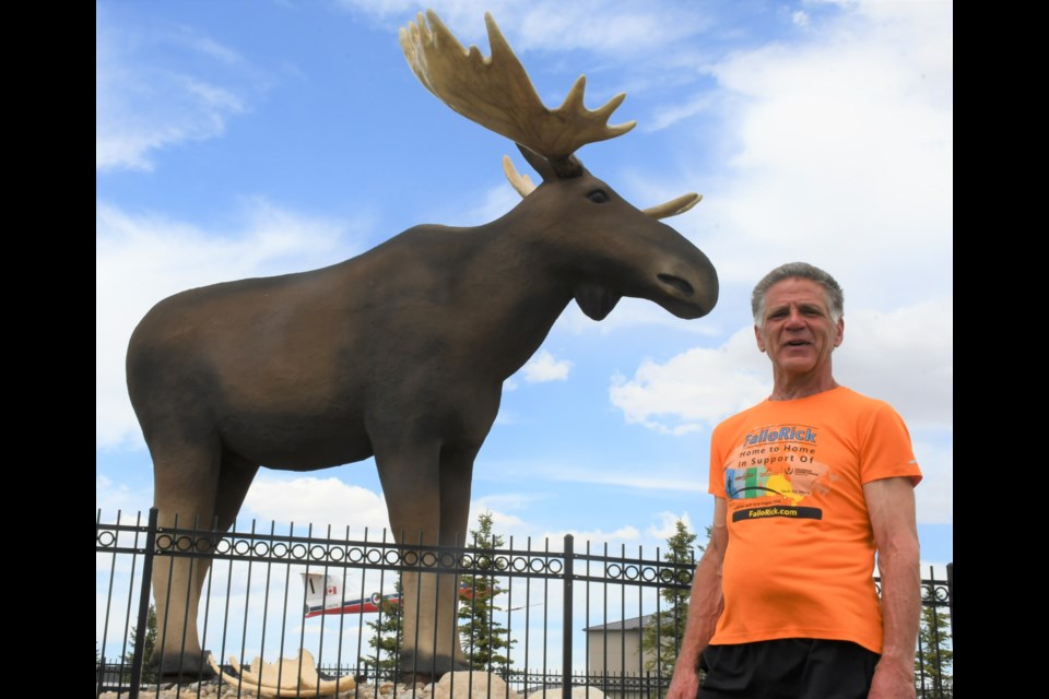 Rick Fall poses near Mac the Moose during his stop in Moose Jaw on May 2. Photo by Jason G. Antonio 