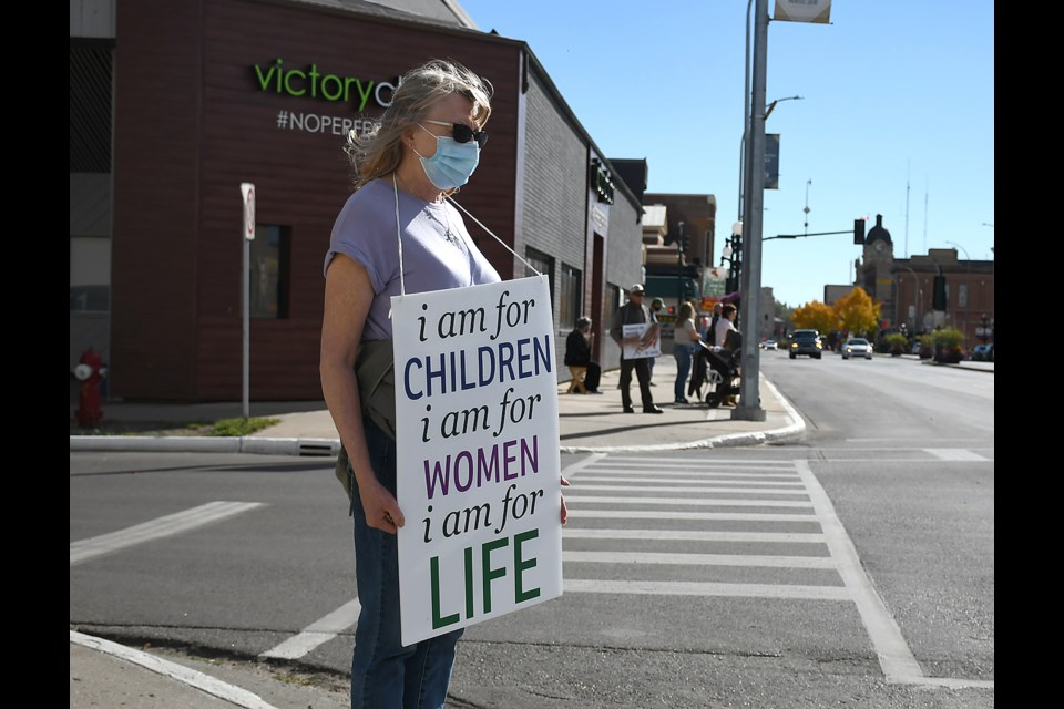 Moose Jaw Right to Life president Jean Landry with her sign on Main Street Sunday afternoon.