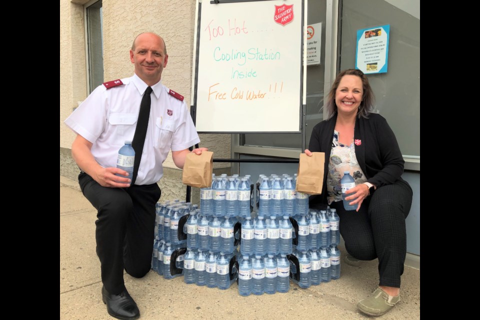 The Salvation Army's Lt. Lester Ward and Sonya Bowles, family services co-ordinator, display some of the water and bagged breakfasts the organization is now offering for free. Photo by Jason G. Antonio