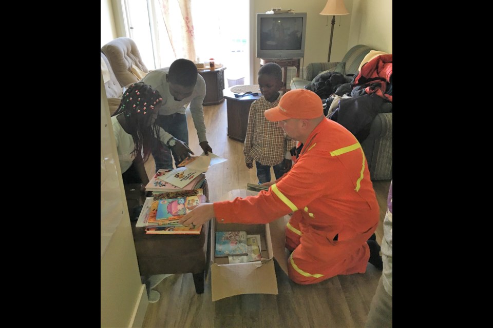 Kristian Sjoberg, left, drops off some books as part of SaskTel's charity initiatives during 2018. (submitted photograph)
