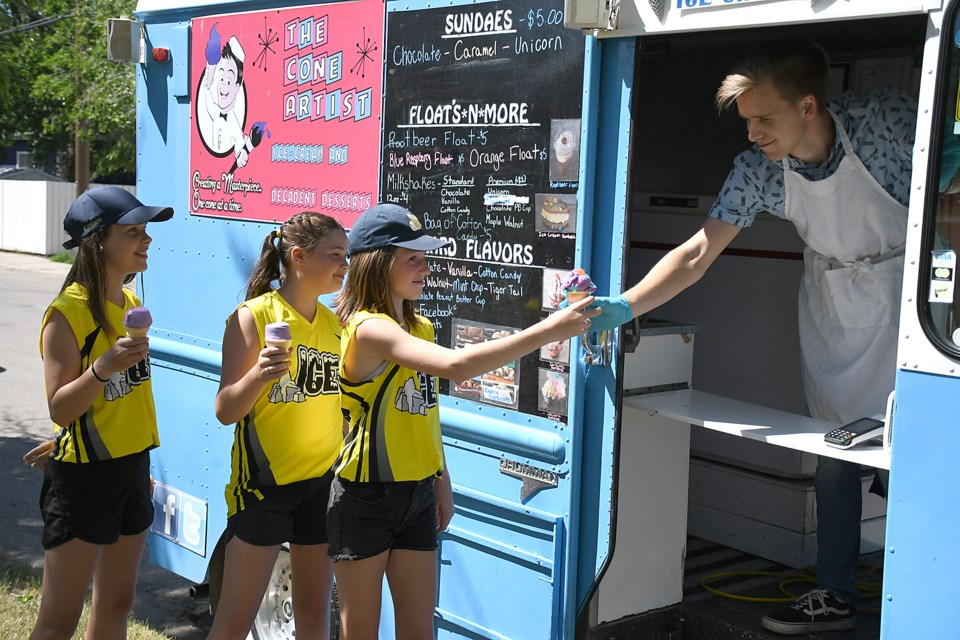 Members of the Moose Jaw Ice stop for ice cream at The Cone Artist outside Elgin Park while in midst of a bottle drive.