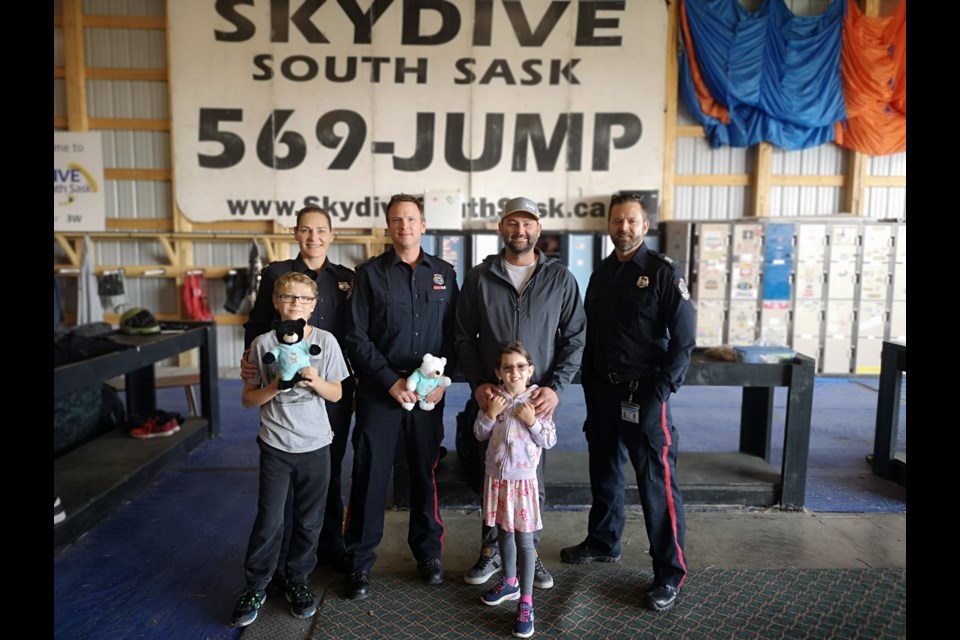 Officers pose for a photo before making the jump. Left to right: Laurel Marshall, Greg Hovdestead, Chad Mehl (photographer with the RPS), and Pierre Beauchesne