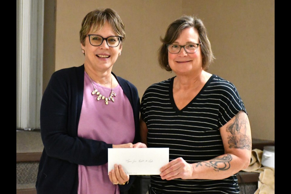 Brenda Havanka, board president of Moose Jaw Right to Life, accepts a $300 cheque from Donna Appel, president of St. Joseph Parish's Catholic Women's League. Photo by Jason G. Antonio