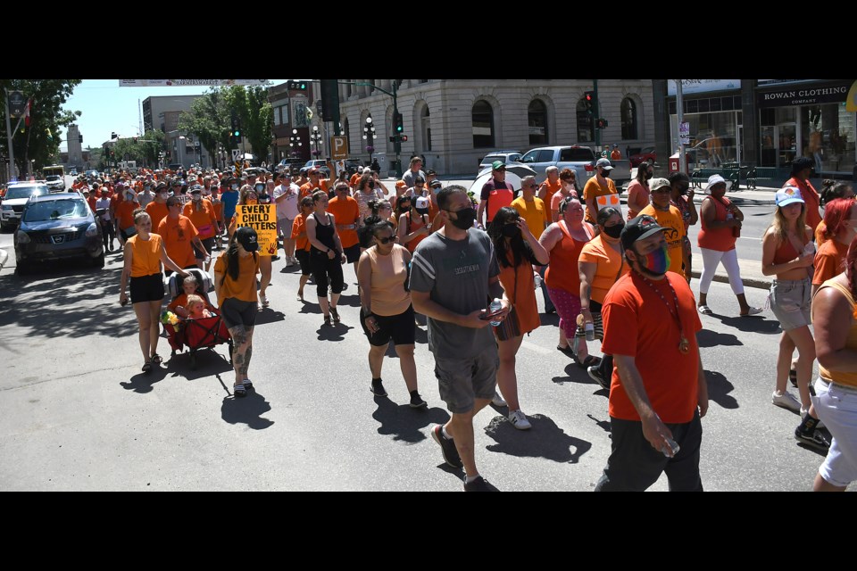 The more than 250 participants in the Standing in Integrity Rally march down Main Street to close out the event.