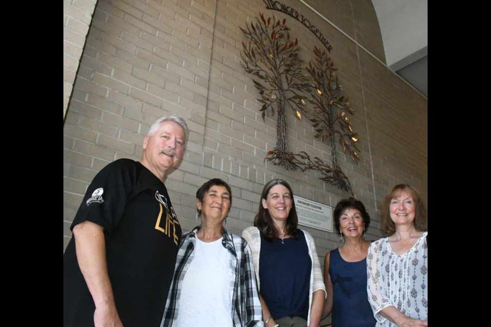 Mayor Clive Tolley, Lynn Kirk with Square One Community Inc., Jody Oakes with the John Howard Society, artist Laurette Keen and Della Ferguson, chairwoman of SOC Inc., gather inside city hall to celebrate the installation of artwork that supports a campaign to address mental illness and homelessness. Photo by Jason G. Antonio 