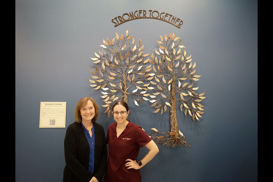 The 'Stronger Together' tree is now located at the Circle Medical Centre. Left to right: Della Ferguson and Dr. Karissa Brabant.