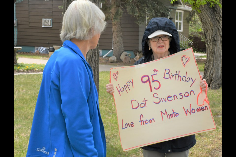 Kathleen Froese shows the sign she made to celebrate Dot Swenson’s birthday on May 29. Photo by Jason G. Antonio 