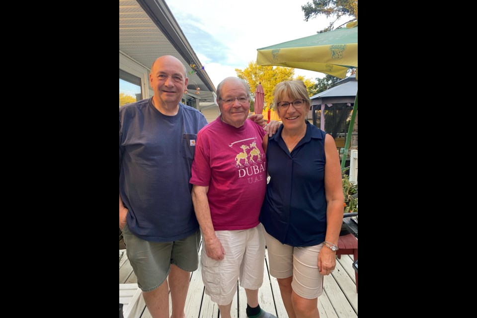Barry Wimmer (left), with former grade six teacher Brock Crysler (centre), and Karen Wimmer (right)