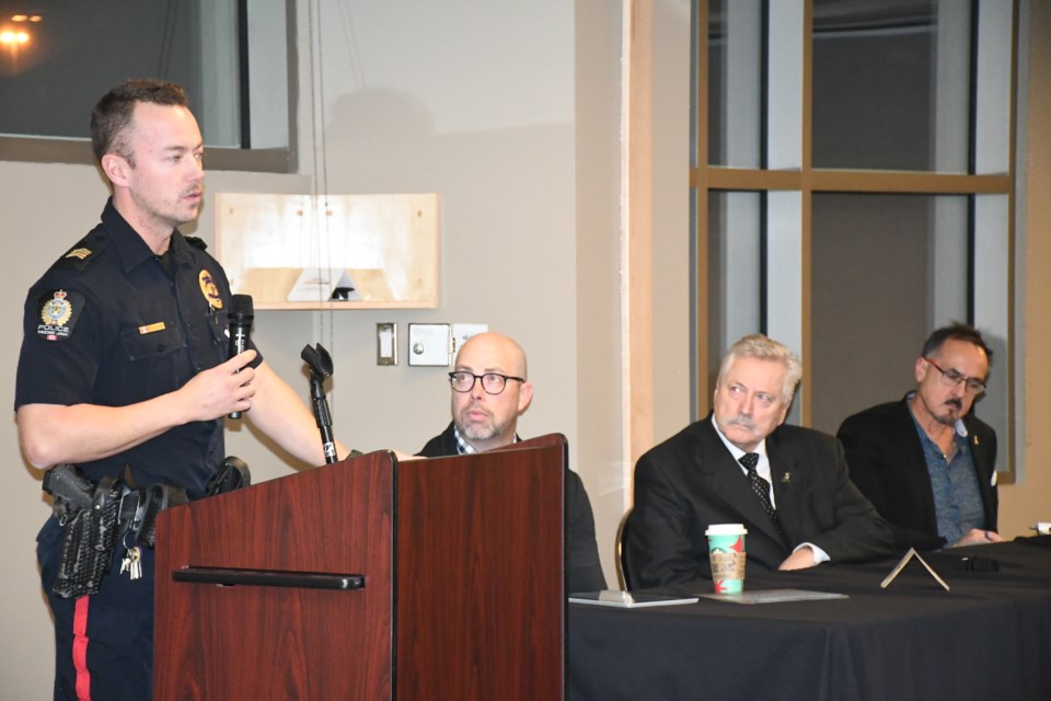 Staff Sgt. Taylor Elder (left) presents data from the photo radar on Highway 1 during the town hall. Photo by Jason G. Antonio