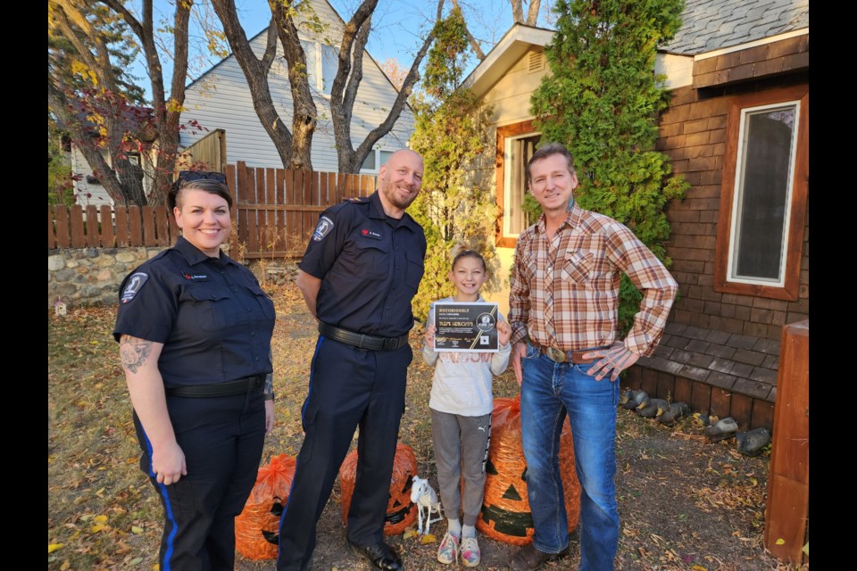 City Bylaw Officers Cristin Korchinski and Brian Simmer, along with Trevor Henrickson and his daughter, Katie. Photo submitted