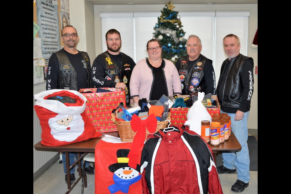 The Canadian UN-NATO Veterans Group donated food, warm, clothes, toque and gloves to the Riverside Mission on Dec. 17. Bud Roy, vice president, right, president Doug Publicover, Don McDonald and Robert Kilbride present the food and clothes collected to Rachel Mullens, centre, interim manager of Riverside Mission. (Matthew Gourlie) 