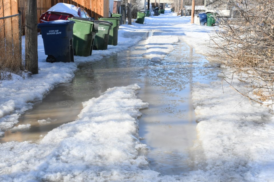 An alley behind Home Street East is filled with water after a pipe burst nearby. Photo by Jason G. Antonio 