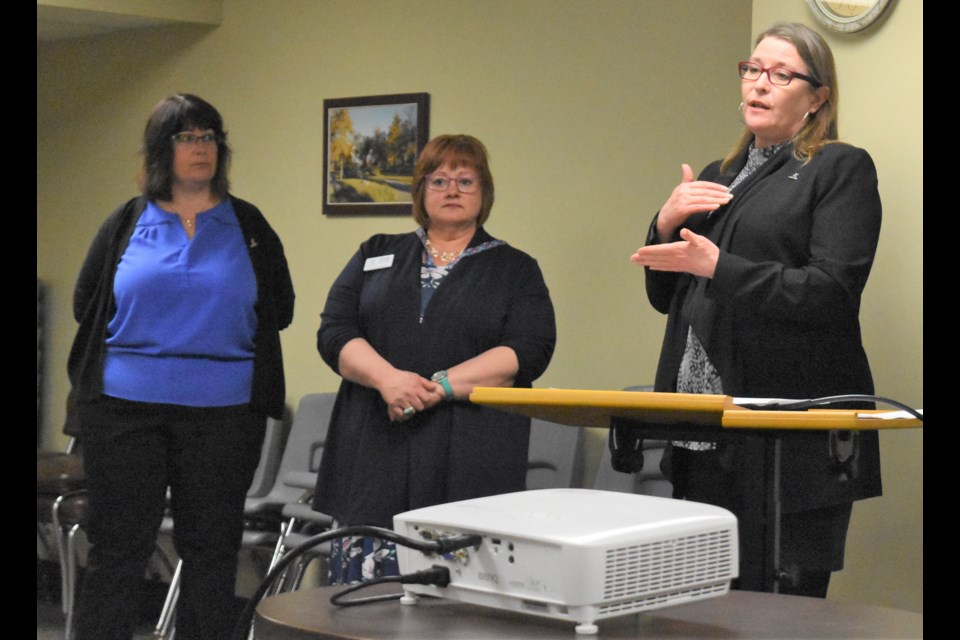 Debbie Irish, CFO of the Canadian Council on Rehabilitation and Work, Lizanne Knox-Beam, employment co-ordinator, and Maureen Haan, CEO and president, speak during the CCRW's grand re-opening. Photo by Jason G. Antonio