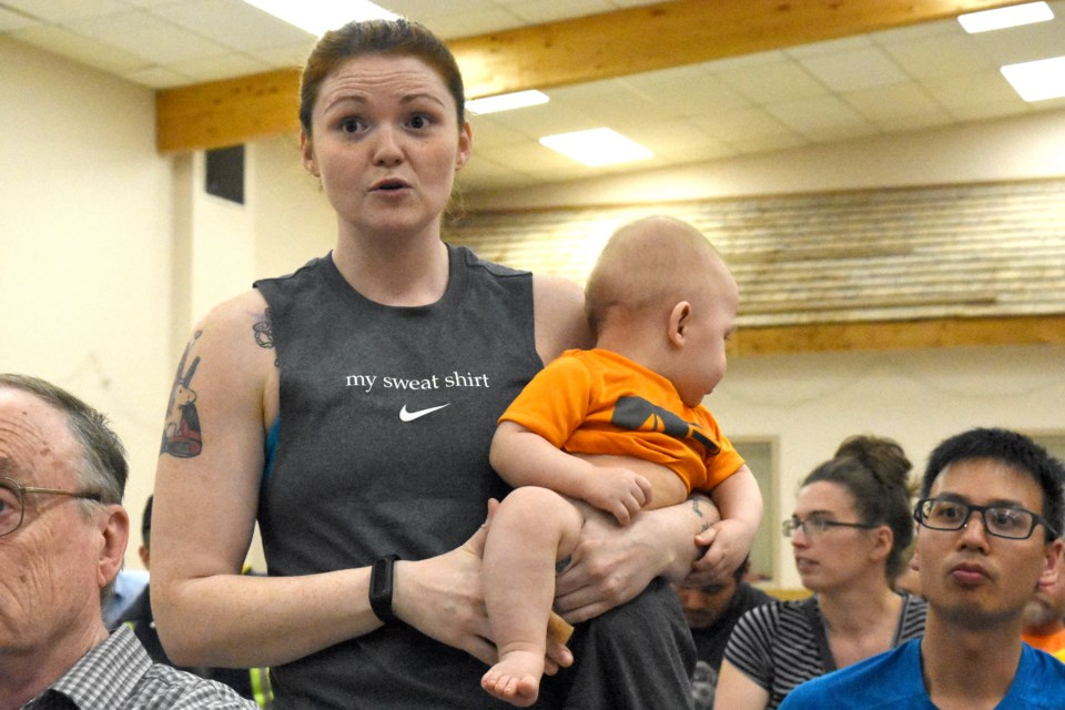 YMCA member Beth Gable expresses her concern about the organization shutting down, along with uncertainty about child care, during the community meeting on May 28. Photo by Jason G. Antonio