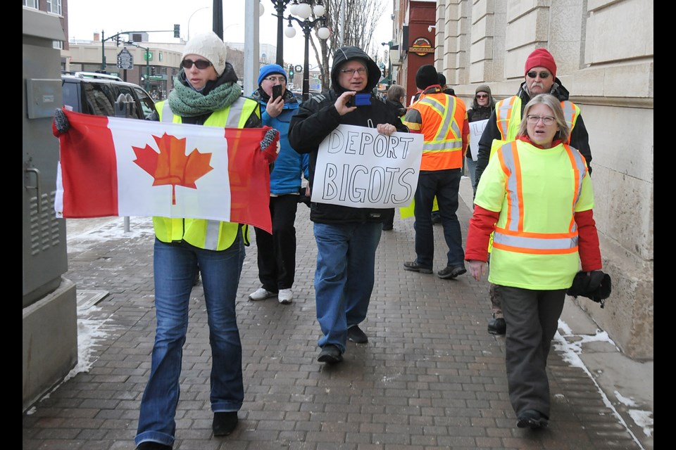 Yellow vest protesters and counter-protesters picket in front of City Hall on Saturday afternoon. Randy Palmer photograph