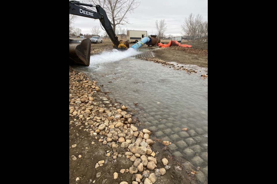 Water gushes from a pipe as contractors flush and disinfect a new water supply line near the high-service reservoir pump house. Photo courtesy City of Moose Jaw