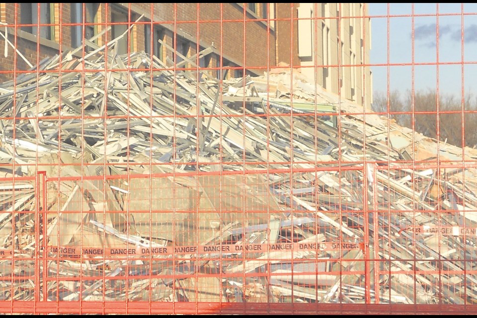 Debris mounts up behind the former Union Hospital as the inside is gutted during demolition in spring 2016. File photo
