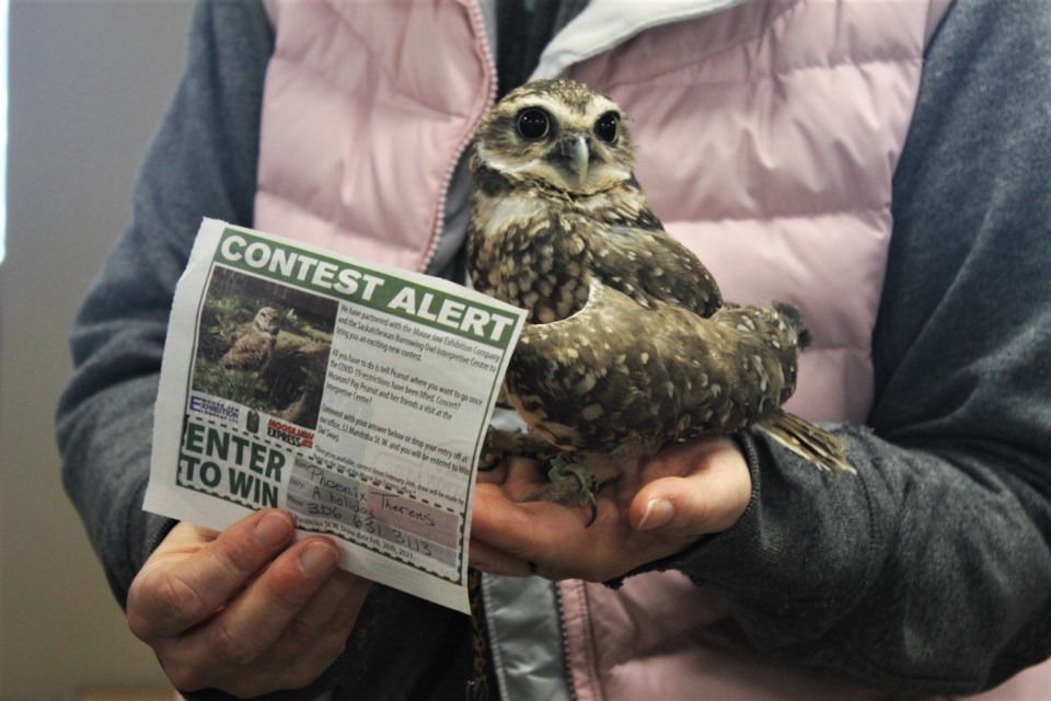 Cricket poses with the winning entry slip naming Phoenix Therens during the in-office draw.