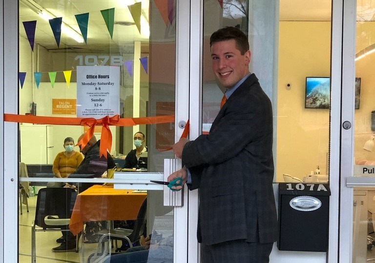 NDP candidate Talon Regent cuts the ribbon to celebrate the opening of this new campaign office on Main Street in Moose Jaw.