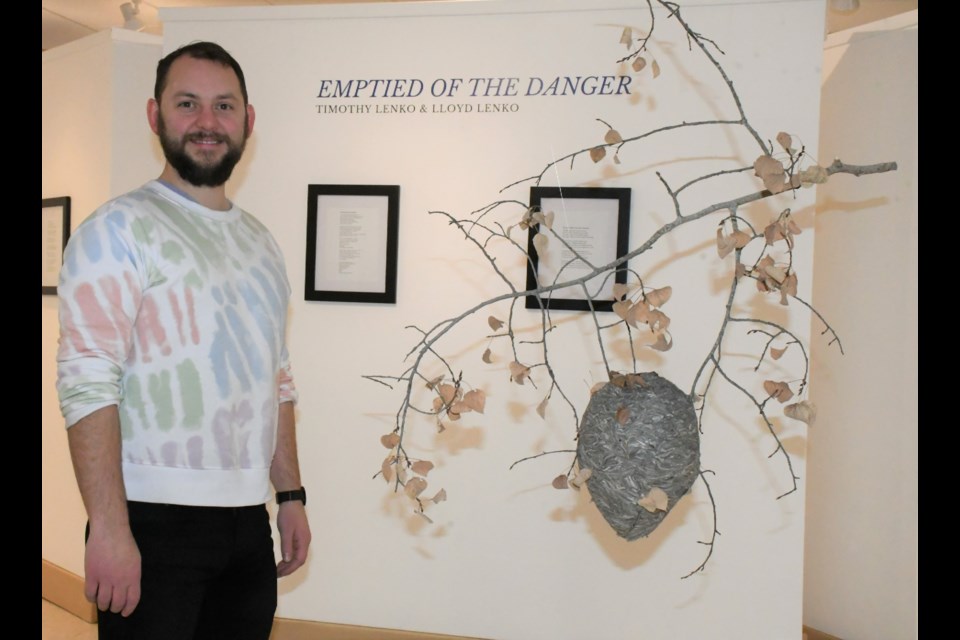 Timothy Lenko stands near his exhibit at the Moose Jaw Cultural Centre. His project is entitled “Emptied of the Danger” and features hives his father, Lloyd, collected and poems he wrote. Photo by Jason G. Antonio 