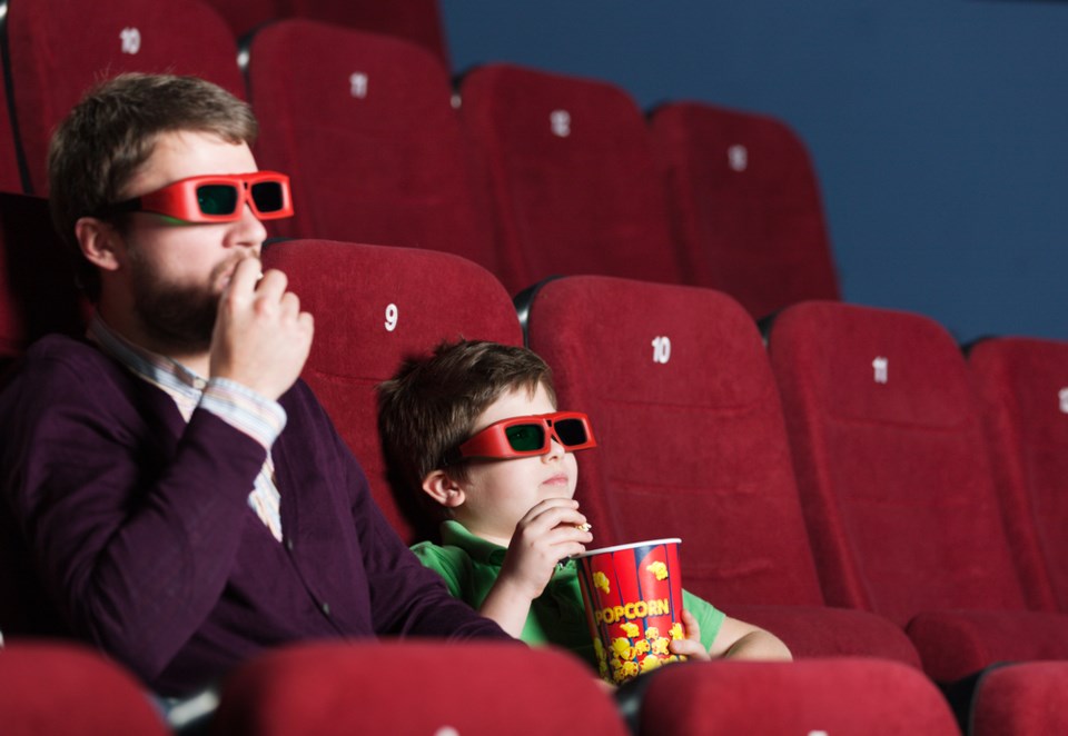 dad watching 3D film theatre shutterstock