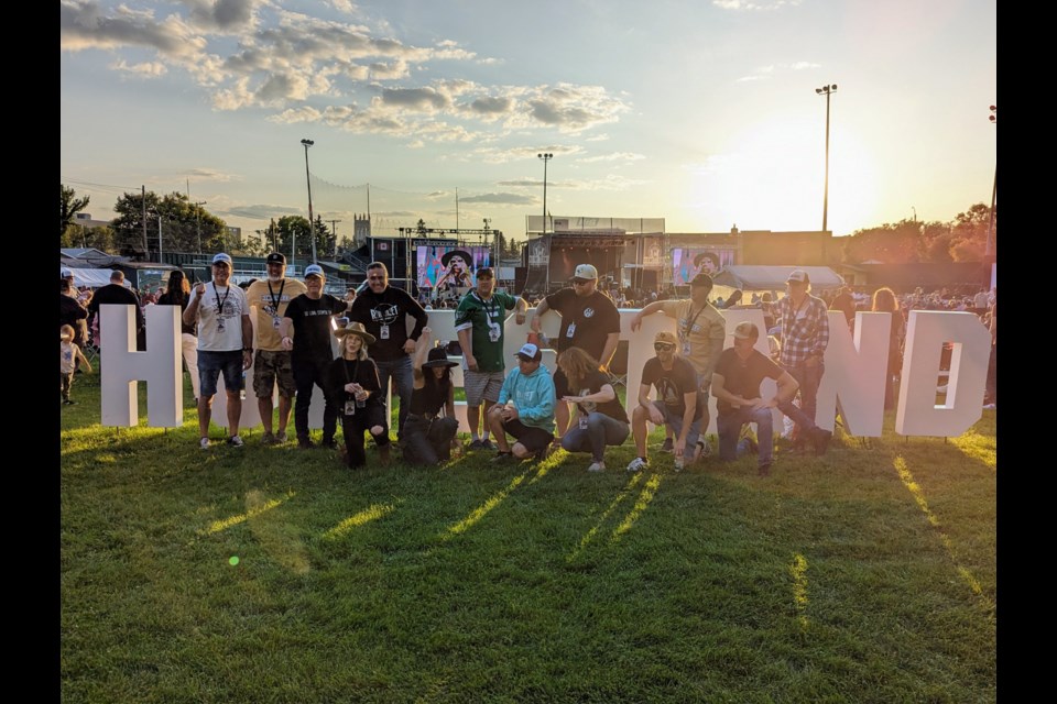 The Homestand '23 organizing committee take a group photo as Lindi Ortega rocks the stage