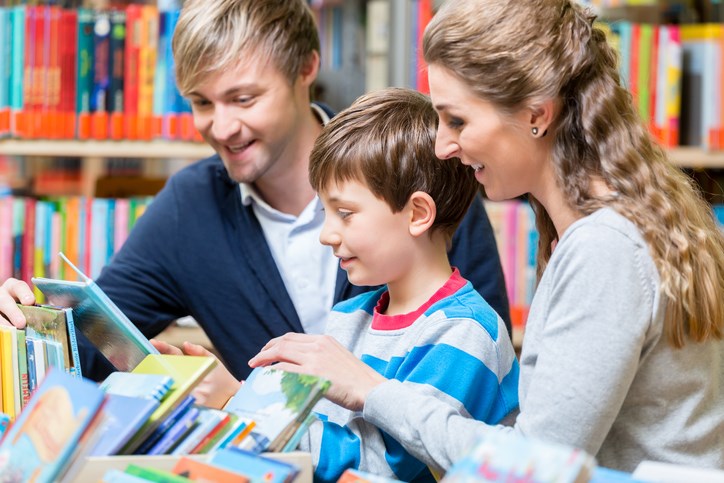 family reading at library getty images