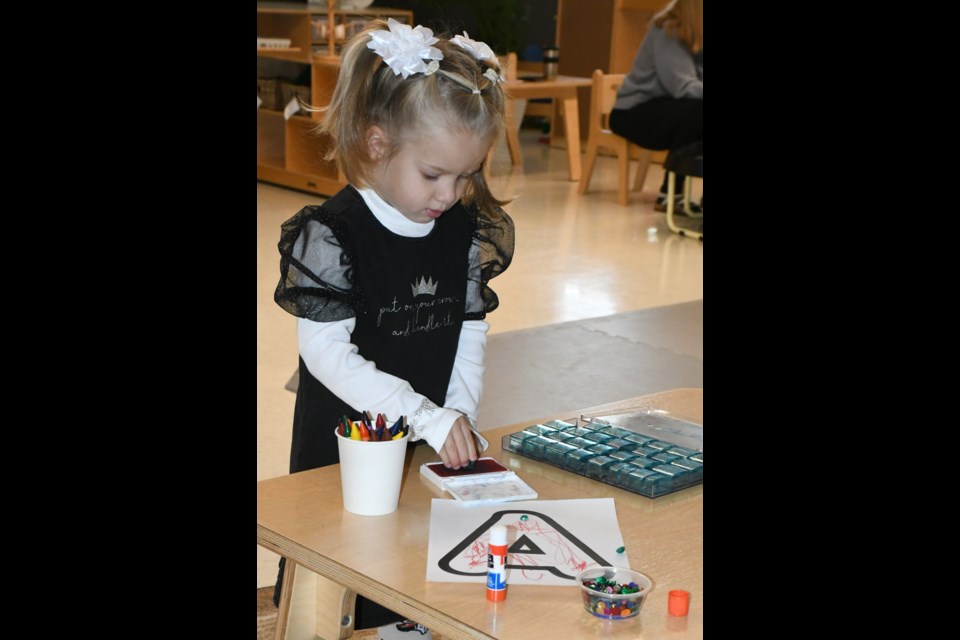 Avrora Zenzura, 3, plays with stamps and other colouring items. Photo by Jason G. Antonio 