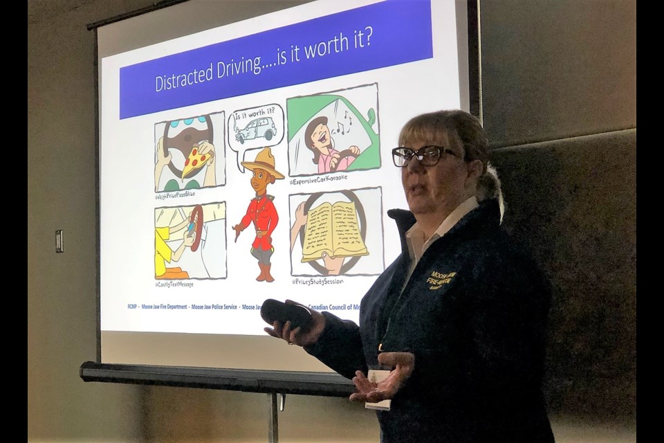 Cathie Bassett, public education officer with the Moose Jaw and District Fire Department, makes a presentation on distracted driving at the Saskatchewan Association of Fire Chiefs convention. (Matthew Gourlie photograph)