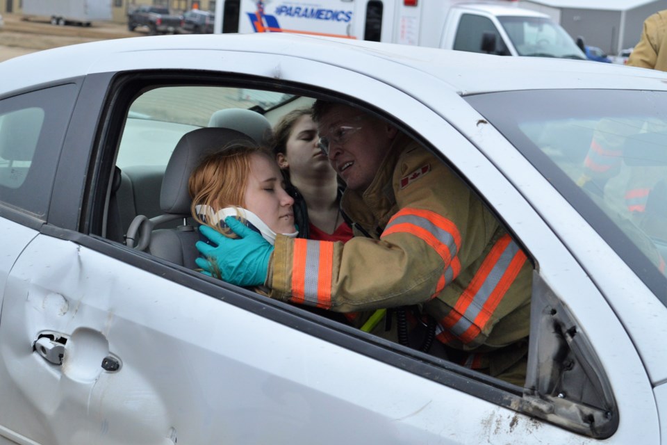 A member of the Moose Jaw Fire Department stabilizes a neck brace on one of the students that were taking part in a mock crash during the PARTY program at Dr. F.H. Wigmore Hospital. (Matthew Gourlie photograph)