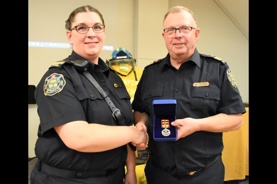In 2019, Caronport Fire Chief Rod Appleby (right) received the Governor General’s Fire Services Exemplary Service Medal and two bars for his 40 years of service with the department. Here he accepts the award from former deputy chief Amy Long. After 16 years as chief, Appleby is stepping down and returning to a regular fireman role. File photo