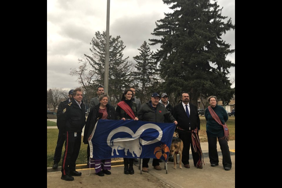 Pictured left to right:  Front row: Police Chief Rick Bourassa; Rosemarie Stewart-Indigenous Student Advisor; Renee Fayant-Flag raiser, Saskatchewan Polytech Student; Darrell Hawman-Saskatchewan Polytechnic Knowledge Keeper and New Southern Plains Metis Local president; Greg Lawrence- MLA for Moose Jaw Wakamow and Marlene Dormuth- Saskatchewan Polytechnic Indigenous Student Centre Coordinator 
Unfortunately the individuals in the back row are not all visible; our apologies.   
Back row:  Lee Pearce-Saskatchewan Polytechnic Manager of Health and Safety; Patrick Connolly-New Southern Plains Metis Local #160 Director at Large; Darlene Veroba-New Southern Plains Metis Local #160 Treasurer 
