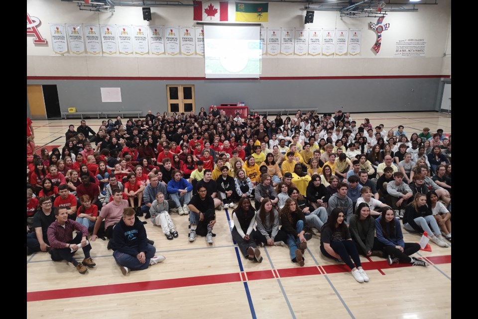 Students from each grade wore matching colours to form the four quadrants of the traditional Indigenous medicine wheel. 
