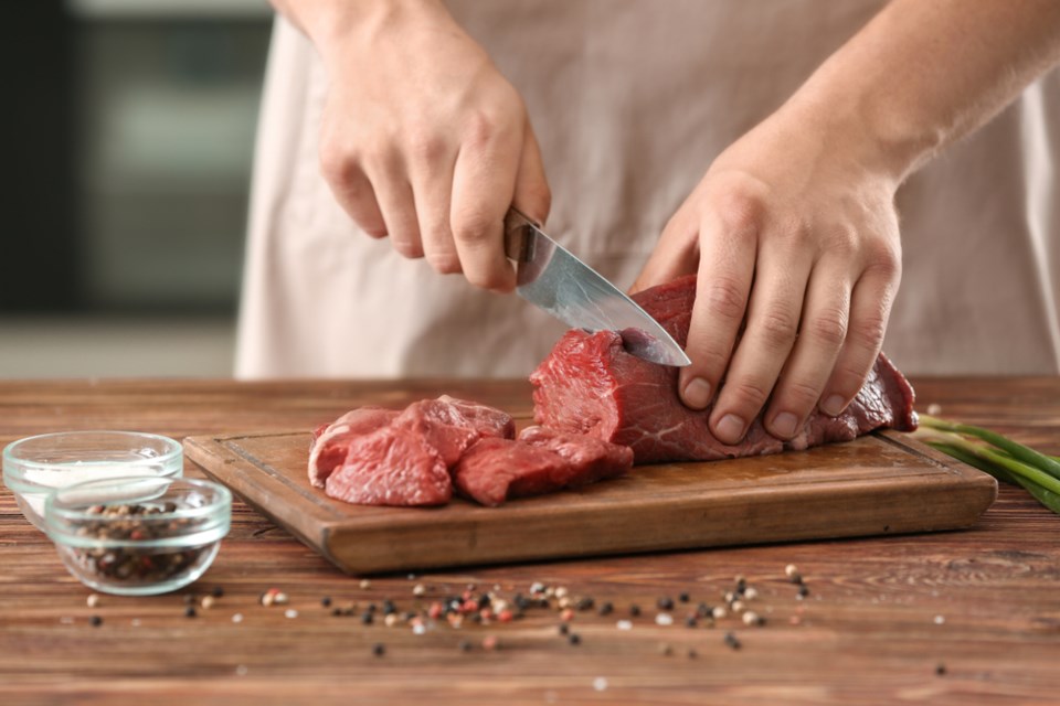 cutting raw meat shutterstock