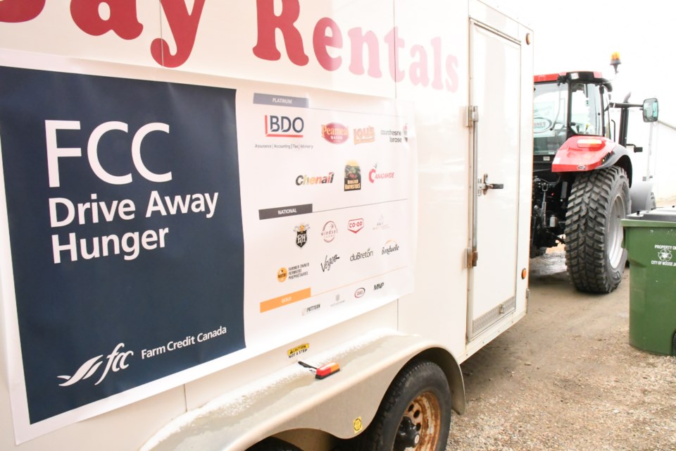 Farm Credit Canada held its 15th annual Drive Away Hunger campaign on Oct. 9 and used two tractors to collect food from throughout Moose Jaw and deposit the supplies at the food bank. Photo by Jason G. Antonio