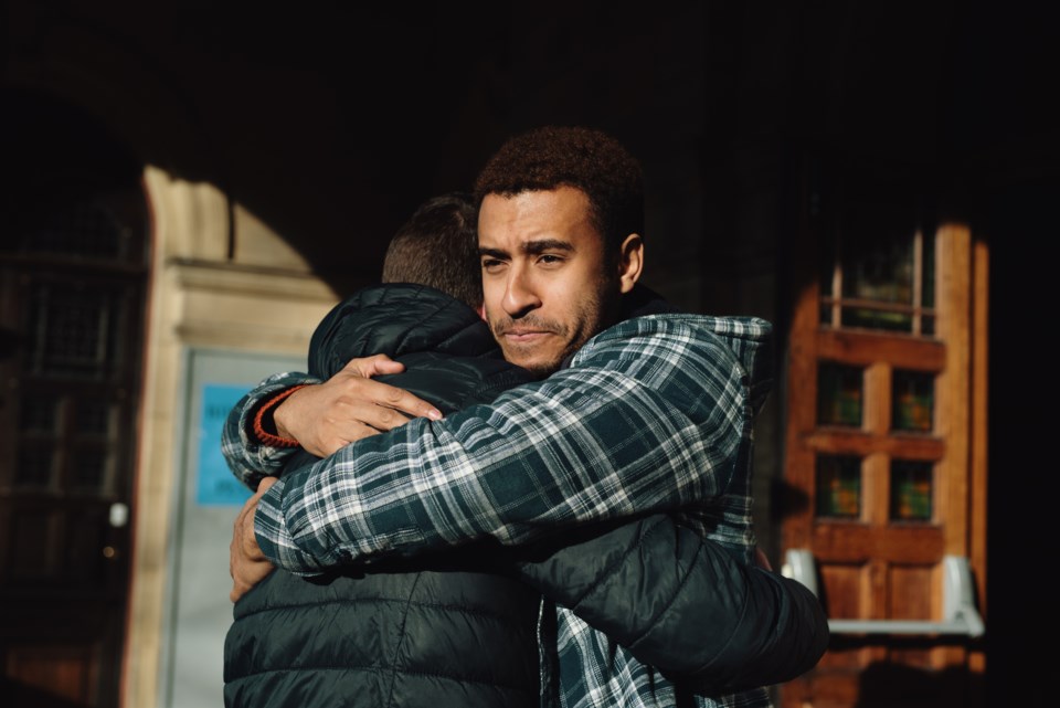 Two men hugging (Sarah Mason - DigitalVision - Getty Images)