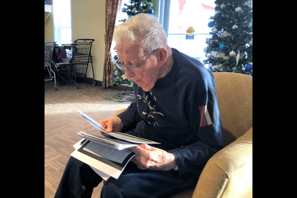 Allen Cameron, a Second World War veteran, reads through the service records of his brother, Morley, who died in the war. New information shows how Morley likely died. Photo by Jason G. Antonio 