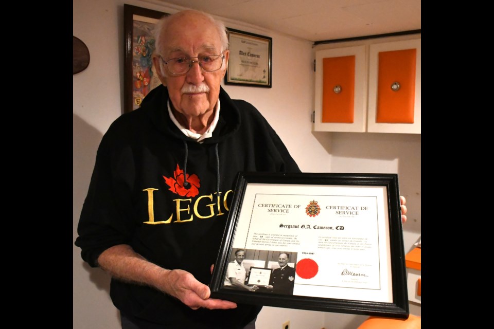 Veteran Alex Cameron holds a certificate of service appreciation award he received after retiring from the military in 1987 after 33 years. Photo by Jason G. Antonio