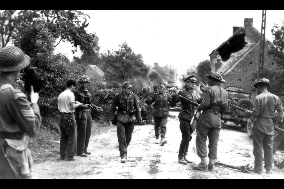 This action picture was taken just as Maj. David Currie and his small group of Canadians closed the last escape route for the remnants of two German armies and sealing them in. Currie (third from left with pistol in hand) earned a Victoria Cross for this action. Photo courtesy Canadian Encyclopedia