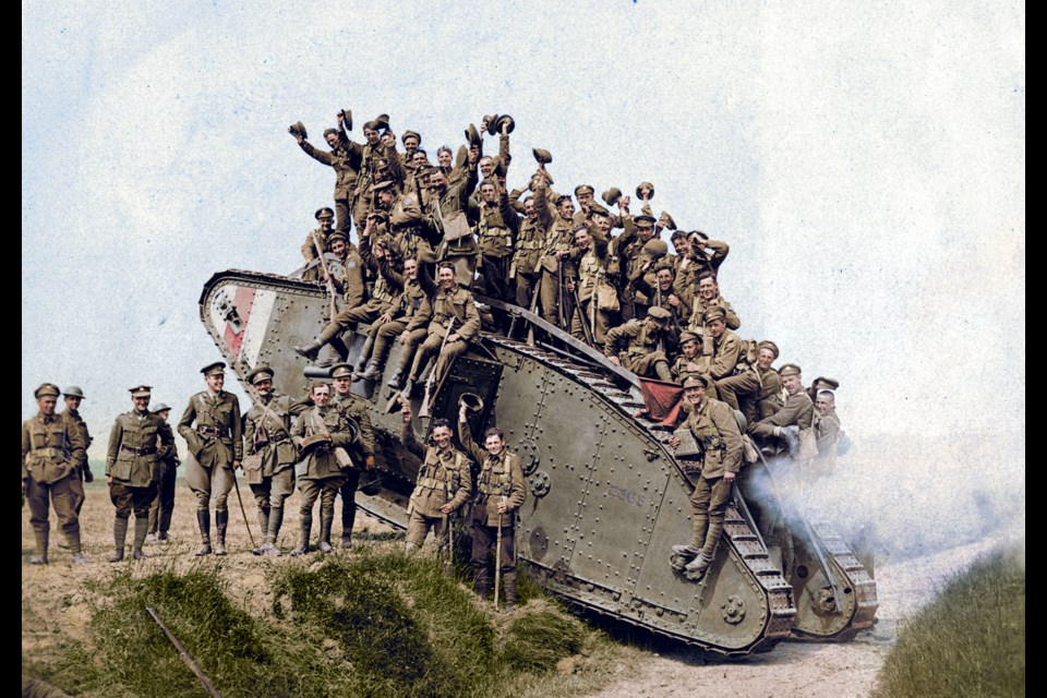 Members of the 5th Canadian Mounted Rifles return from combat while piled on a tank in this photo from August 1918. Photo courtesy Canadian War Museum