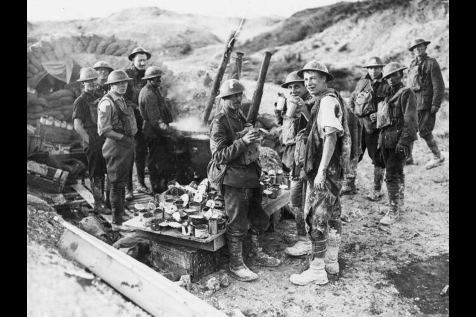 A wounded Canadian soldier drinks hot coffee at a soup kitchen 100 yards from German lines, amid the push on Hill 70, in August 1917 during the First World War. Photo courtesy Library and Archives Canada