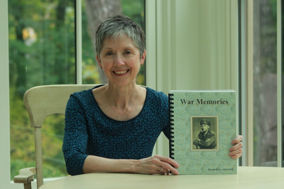 Karen Hunter holds a copy of her father's memoir from his time during the Second World War. File photo