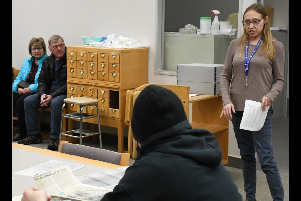 Stephanie Jeanes, an archival assistant, talks about the library's archive department during an open house. Photo by Jason G. Antonio