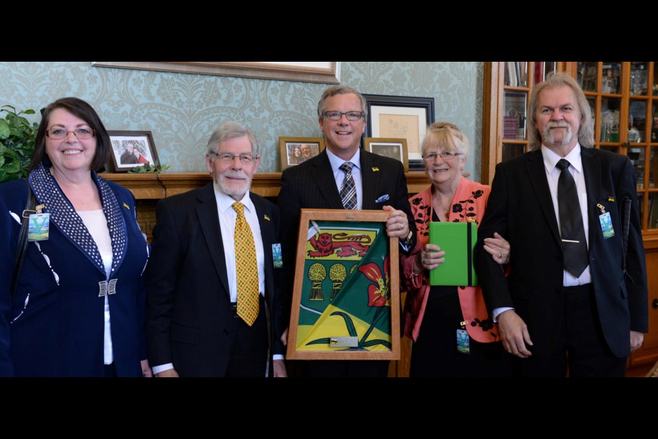 Saskatchewan premier Brad Wall presents Anthony Drake with a framed Saskatchewan flag after welcoming him at the Legislature in 2016. Pictured are Gail Hapanowicz, Anthony Drake, Brad Wall, Joan Drake and Mirek Hapanowicz.