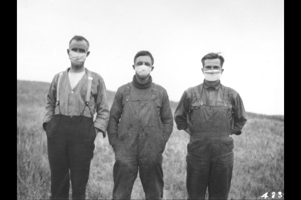 Photo of Alberta farmers protecting themselves from the Spanish Flu. Photo courtesy of Library and Archives Canada. 