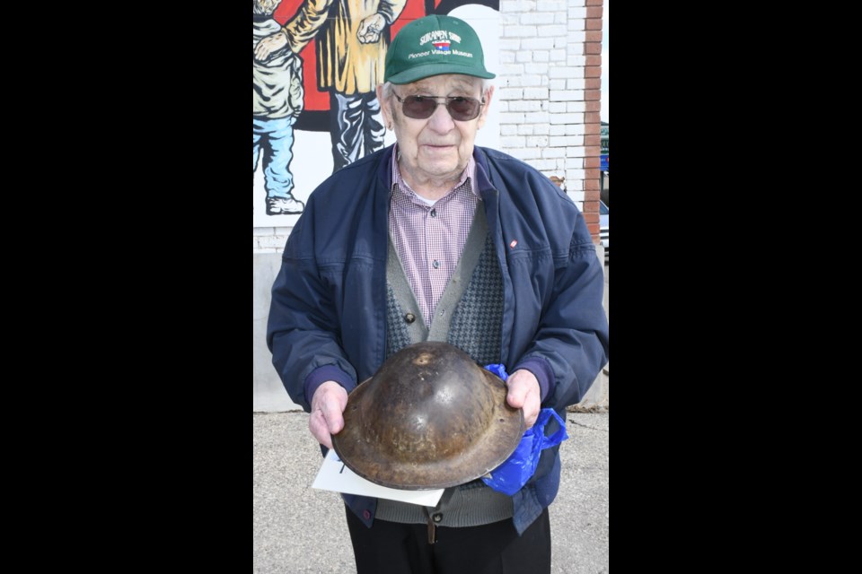 Vern Mittelholtz holds the helmet his father Edmon wore during the First World War. The dent on top of the helmet occurred when Edmon fought at Vimy Ridge from April 9 to 12, 1917. Photo by Jason G. Antonio